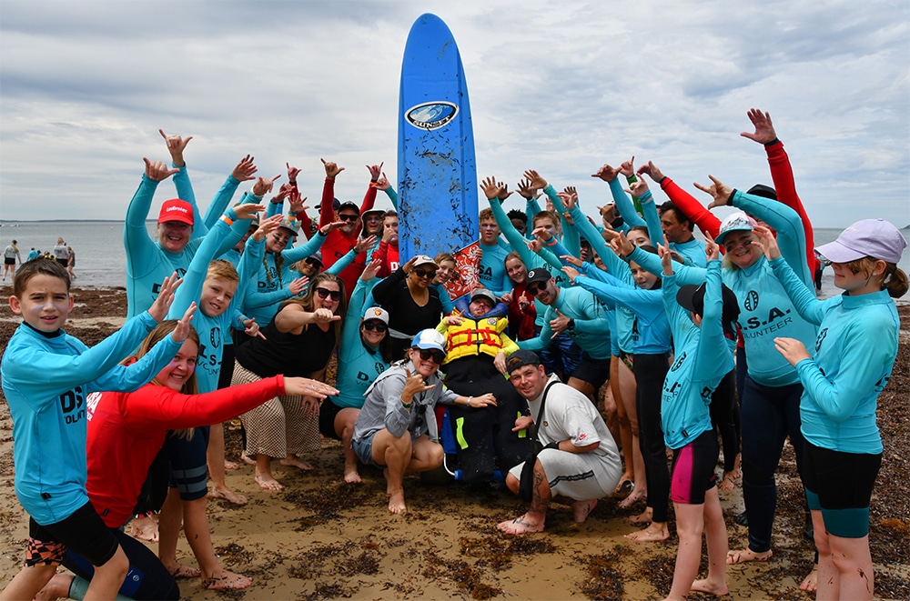 Disabled surfers hit the beach with a smile and a wave